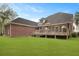 Spacious backyard with a wooden deck and well-maintained lawn area at 4204 Magnolia Ct, North Charleston, SC 29420