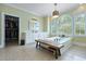 Bright primary bathroom features a large tub, a bench, and a walk-in closet at 4204 Magnolia Ct, North Charleston, SC 29420