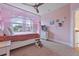 Bright, pink bedroom with a canopy bed, natural light, and cozy carpeting at 4204 Magnolia Ct, North Charleston, SC 29420