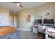 Bright bedroom featuring an office area, a door and a ceiling fan at 4204 Magnolia Ct, North Charleston, SC 29420