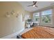 Bright bedroom featuring an office area, two windows, and a ceiling fan at 4204 Magnolia Ct, North Charleston, SC 29420