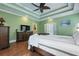 Spacious primary bedroom features tray ceilings, ceiling fan, and a wooden dresser with television at 4204 Magnolia Ct, North Charleston, SC 29420