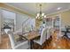 Spacious dining room featuring hardwood floors, chandelier, and access to the kitchen at 4204 Magnolia Ct, North Charleston, SC 29420