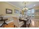 Charming dining room featuring hardwood floors, a chandelier, and large windows at 4204 Magnolia Ct, North Charleston, SC 29420