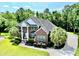 Stately two-story brick home with a columned front porch and meticulously landscaped yard at 4204 Magnolia Ct, North Charleston, SC 29420