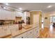 Open kitchen with island, granite countertops, stainless steel appliances, and hardwood floors at 4204 Magnolia Ct, North Charleston, SC 29420