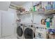 Well-organized laundry room with shelving and modern washer and dryer units at 4204 Magnolia Ct, North Charleston, SC 29420