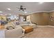Spacious living room featuring plush sectional sofa, leather ottoman, and seamless access to the kitchen at 4204 Magnolia Ct, North Charleston, SC 29420