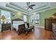 Green main bedroom showcasing a large bed with luxurious wooden furniture at 4204 Magnolia Ct, North Charleston, SC 29420