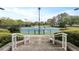 View of well-maintained tennis courts, surrounded by mature trees and greenery, accessible by concrete steps at 4204 Magnolia Ct, North Charleston, SC 29420