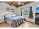 Bedroom with wooden paneled ceiling with a window providing natural light and a gray scale aesthetic at 4701 Apple St, North Charleston, SC 29405