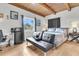 Cozy bedroom with wood-beamed ceilings, a comfortable bed, and a functional workspace at 4701 Apple St, North Charleston, SC 29405