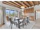 Dining area with a modern table set, outdoor patio, bright natural light, and hardwood floors at 4701 Apple St, North Charleston, SC 29405