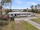 Sprawling one-story home with white brick and a metal roof on a beautiful waterfront lot at 4701 Apple St, North Charleston, SC 29405