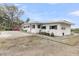 Beautiful home with a painted white brick exterior, black shutters, and landscaped front yard, curb appeal at 4701 Apple St, North Charleston, SC 29405