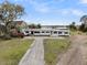 Sprawling one-story home with white brick and a metal roof with a long driveway at 4701 Apple St, North Charleston, SC 29405