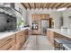 Modern kitchen with stainless steel appliances, custom wood cabinetry, and a marble countertop island at 4701 Apple St, North Charleston, SC 29405