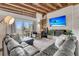 Bright living room featuring a fireplace, large sectional sofa, and access to a patio with lush greenery at 4701 Apple St, North Charleston, SC 29405