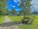 Scenic park with a paved walkway, bench seating and a tennis court in the background at 4701 Apple St, North Charleston, SC 29405