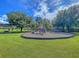 Playground featuring a slide, swings, and climbing structure, surrounded by green grass at 4701 Apple St, North Charleston, SC 29405