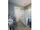 Modern bathroom featuring a glass-enclosed shower with a unique shower head, marble countertop and tile flooring at 527 W Butternut Rd, Summerville, SC 29483