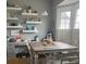 Cozy dining area with open shelving, a functional workspace, and a bright window at 527 W Butternut Rd, Summerville, SC 29483