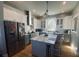 Modern kitchen with stainless steel appliances, island with seating, and stylish white and grey cabinetry at 527 W Butternut Rd, Summerville, SC 29483