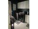 Convenient laundry room featuring modern washer and dryer units, with white cabinets and countertops at 527 W Butternut Rd, Summerville, SC 29483