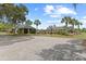 Community basketball court next to a house and an area with mature palm trees and landscaping at 5276 7Th Green Dr, Hollywood, SC 29449