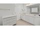 Bathroom featuring double sinks, white cabinetry, tile floors, and a large mirror at 5276 7Th Green Dr, Hollywood, SC 29449
