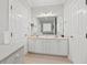 Bathroom featuring double sinks, white cabinetry, tile floors, and a large mirror at 5276 7Th Green Dr, Hollywood, SC 29449