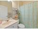 This bathroom features a shower with patterned shower curtain and a sink with a shelf with towels at 5276 7Th Green Dr, Hollywood, SC 29449