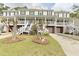 Charming townhome with covered porch, white railings, garage, and landscaped front yard at 5276 7Th Green Dr, Hollywood, SC 29449