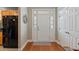 Bright foyer featuring wood floors, and a white door with sidelights and transom window at 5276 7Th Green Dr, Hollywood, SC 29449