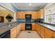 Well-lit kitchen featuring wood cabinets, stainless steel appliances, and stylish countertops at 5276 7Th Green Dr, Hollywood, SC 29449