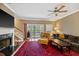 Living room featuring a fireplace, ceiling fan, and sliding glass doors to a balcony at 5276 7Th Green Dr, Hollywood, SC 29449