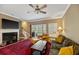 Comfortable living room with fireplace, ceiling fan, and access to the porch at 5276 7Th Green Dr, Hollywood, SC 29449