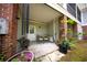 Charming patio with seating, lush greenery, a brick accent wall, and access to the outdoors at 5276 7Th Green Dr, Hollywood, SC 29449