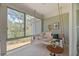 Relaxing screened porch with a hanging swing bed, table, and view of the trees outside at 5276 7Th Green Dr, Hollywood, SC 29449