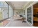 Relaxing screened-in porch with a porch swing and windows looking out to a private wooded area at 5276 7Th Green Dr, Hollywood, SC 29449