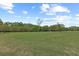 Expansive property featuring lush green spaces and mature trees, offering a serene and picturesque setting at 5276 7Th Green Dr, Hollywood, SC 29449
