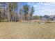 Spacious backyard with several raised garden beds and mature trees, ideal for gardening enthusiasts at 547 Pontoon Rd, Huger, SC 29450