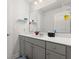 Well-lit bathroom with gray vanity, quartz countertop, and large mirror at 547 Pontoon Rd, Huger, SC 29450