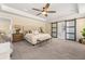 Spacious main bedroom with barn door access to the ensuite, a ceiling fan, and ambient lighting at 547 Pontoon Rd, Huger, SC 29450