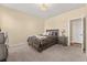 This spacious carpeted bedroom boasts neutral walls and an overhead light fixture at 547 Pontoon Rd, Huger, SC 29450