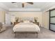 This main bedroom boasts a trey ceiling, fan, and bedside tables with lamps at 547 Pontoon Rd, Huger, SC 29450