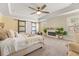 The main bedroom boasts a trey ceiling, fan, fireplace, and sliding barn doors to the ensuite at 547 Pontoon Rd, Huger, SC 29450