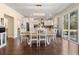 Open-concept dining room with white table and chairs, chandelier, and hardwood floors at 547 Pontoon Rd, Huger, SC 29450