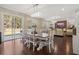 Bright dining room with hardwood floors, a stylish chandelier, and a view to the backyard at 547 Pontoon Rd, Huger, SC 29450