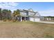 Beautiful two-story home boasts a manicured lawn, mature trees, and an attached two-car garage at 547 Pontoon Rd, Huger, SC 29450